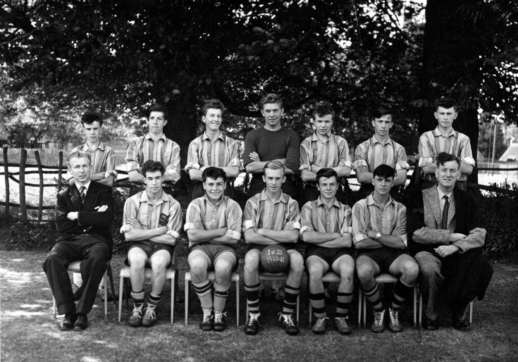 1960-61 First XI Football Team (Back Row) Robert Gardner, John Currill, Laurence Taylor, Robert Cholerton, Robin Print, Rodney Gillett, David Webb (Front Row) Mr P Moore, Roger Mansell, Michael Garaway, Colin Burrows, Andrew Chisman, Willie Wiechec, Mr A. L. Jones